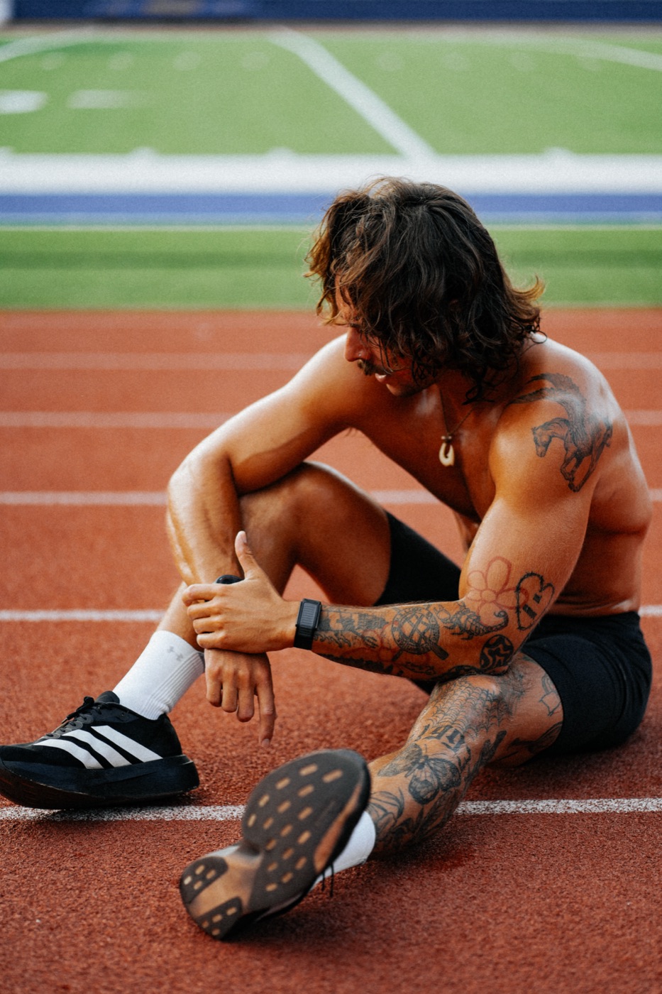Ian Fonville stretching on a track